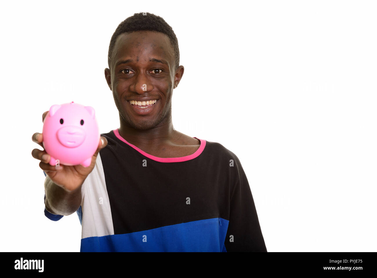 Happy African man smiling holding piggy bank Stock Photo - Alamy