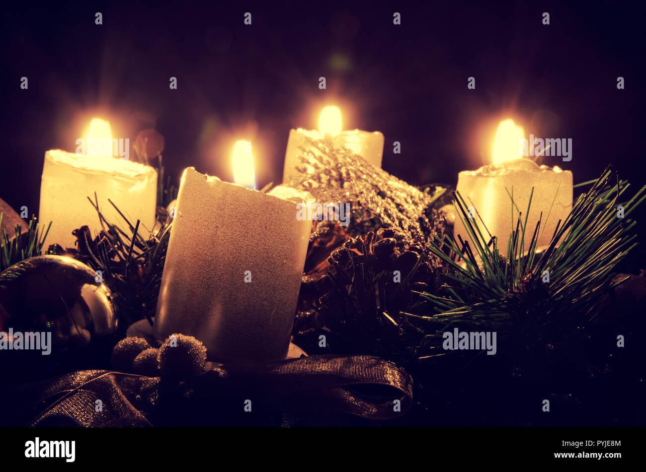 four burning golden candles in advent wreath Stock Photo Alamy