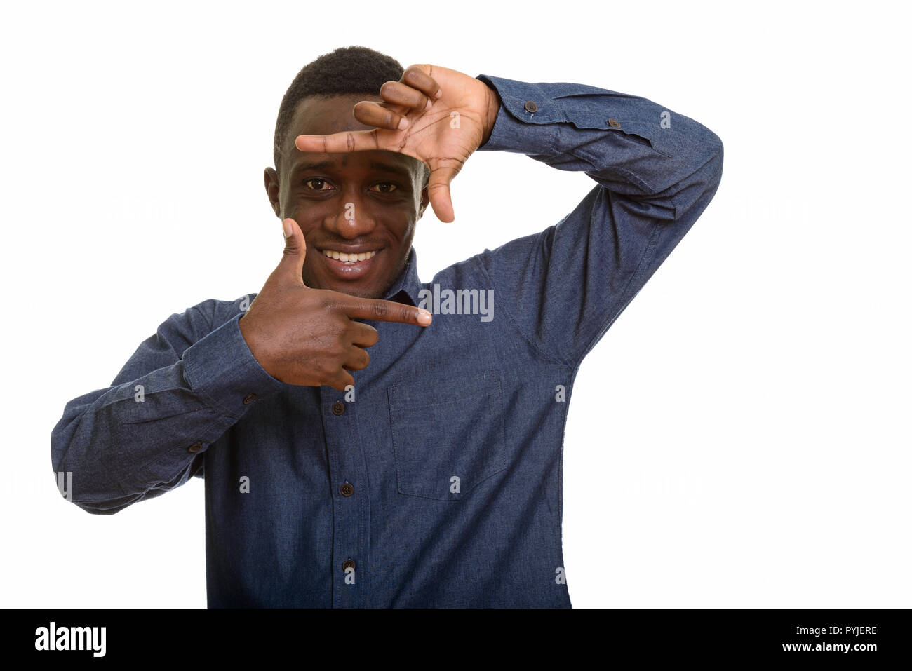 Young happy African man smiling and focusing with fingers  Stock Photo