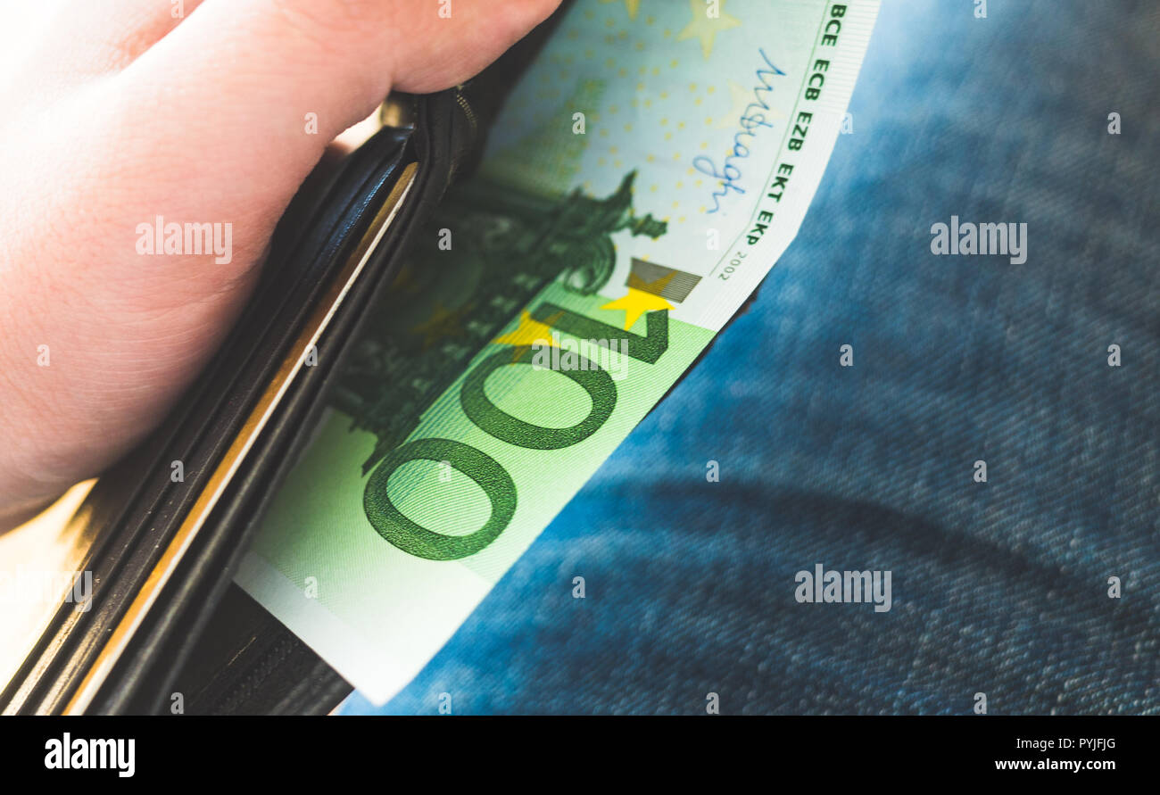 One hundred Euro banknote in black leather wallet Stock Photo - Alamy
