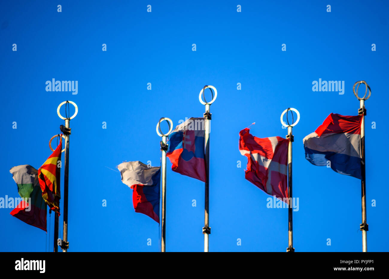 Flags of European countries on flagpoles against the blue sky Stock ...