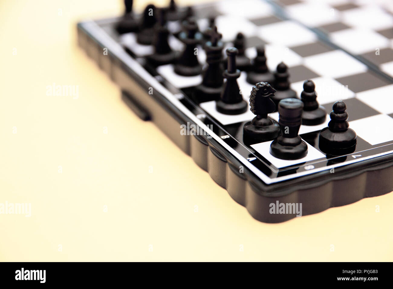 small pocket chess, plastic chess pieces placed on a chessboard on a