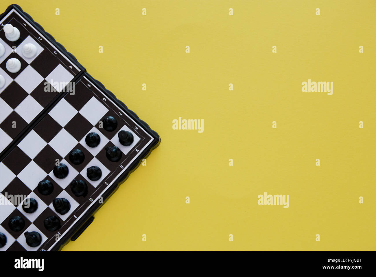small pocket chess, plastic chess pieces placed on a chessboard on a