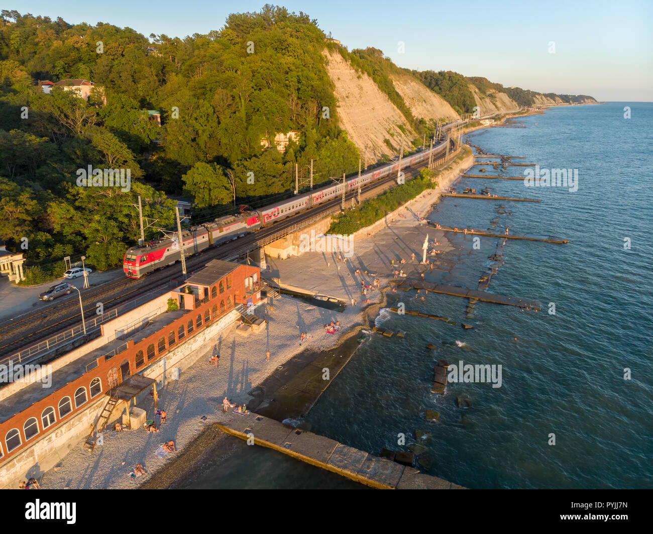 RUSSIA, KRASNODAR KRAI, GIZELE-DERE VILLAGE,  August 13, 2018: A bird's-eye view of Gizel-Dere railway station and passing train along the Black Sea c Stock Photo
