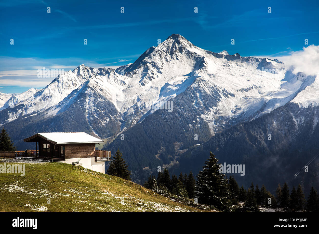 View with lonely house and snow covered mountains on the background Stock Photo