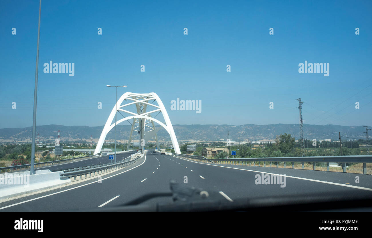 Cordoba, Spain - 2018 july 10th: Driving by Ibn Abbas Firnas Bridge close to Cordoba City. View from the inside of the car. Designed by JL Manzanares  Stock Photo