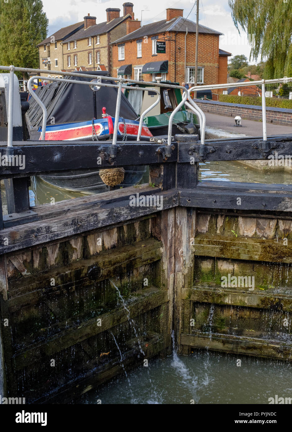 Two narrow boats at lock on Grand Union Canal, near The Canal Museum at Stoke Bruerne on the Grand Union Canal, Northampton, England Stock Photo