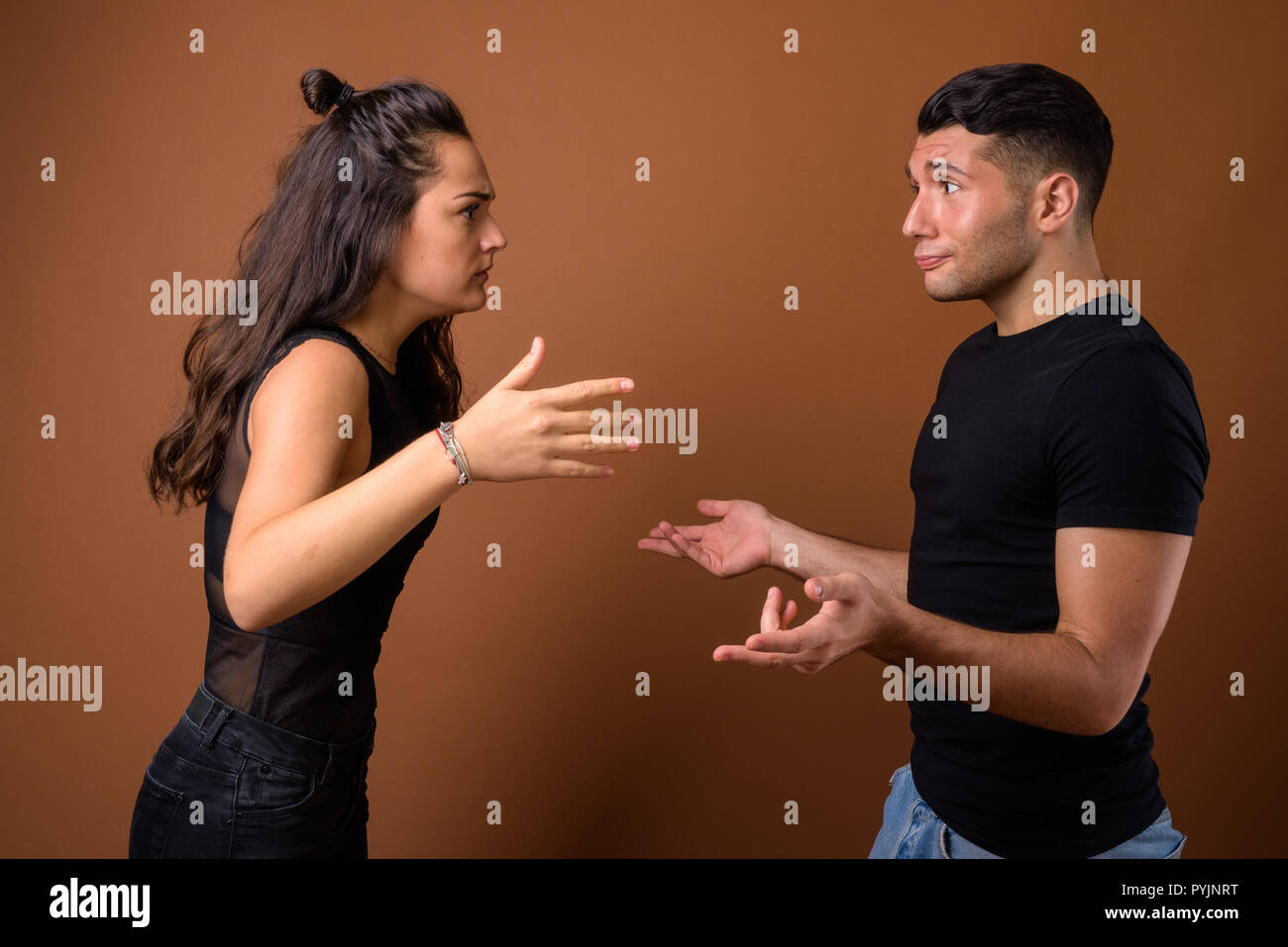 Young couple together and in love against brown background Stock Photo