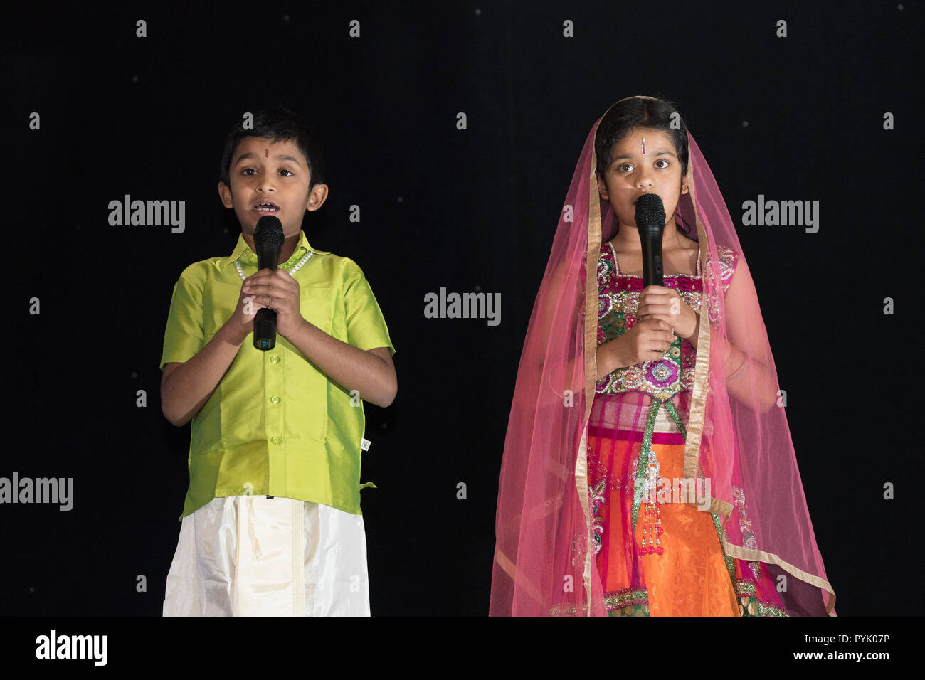 Watford, UK. 27th Oct, 2018. Two children sing a song during a Diwali celebration at the Holywell Community Centre in Watford. Photo date: Saturday, October 27, 2018. Photo: Roger Garfield/Alamy Live News Credit: Roger Garfield/Alamy Live News Stock Photo