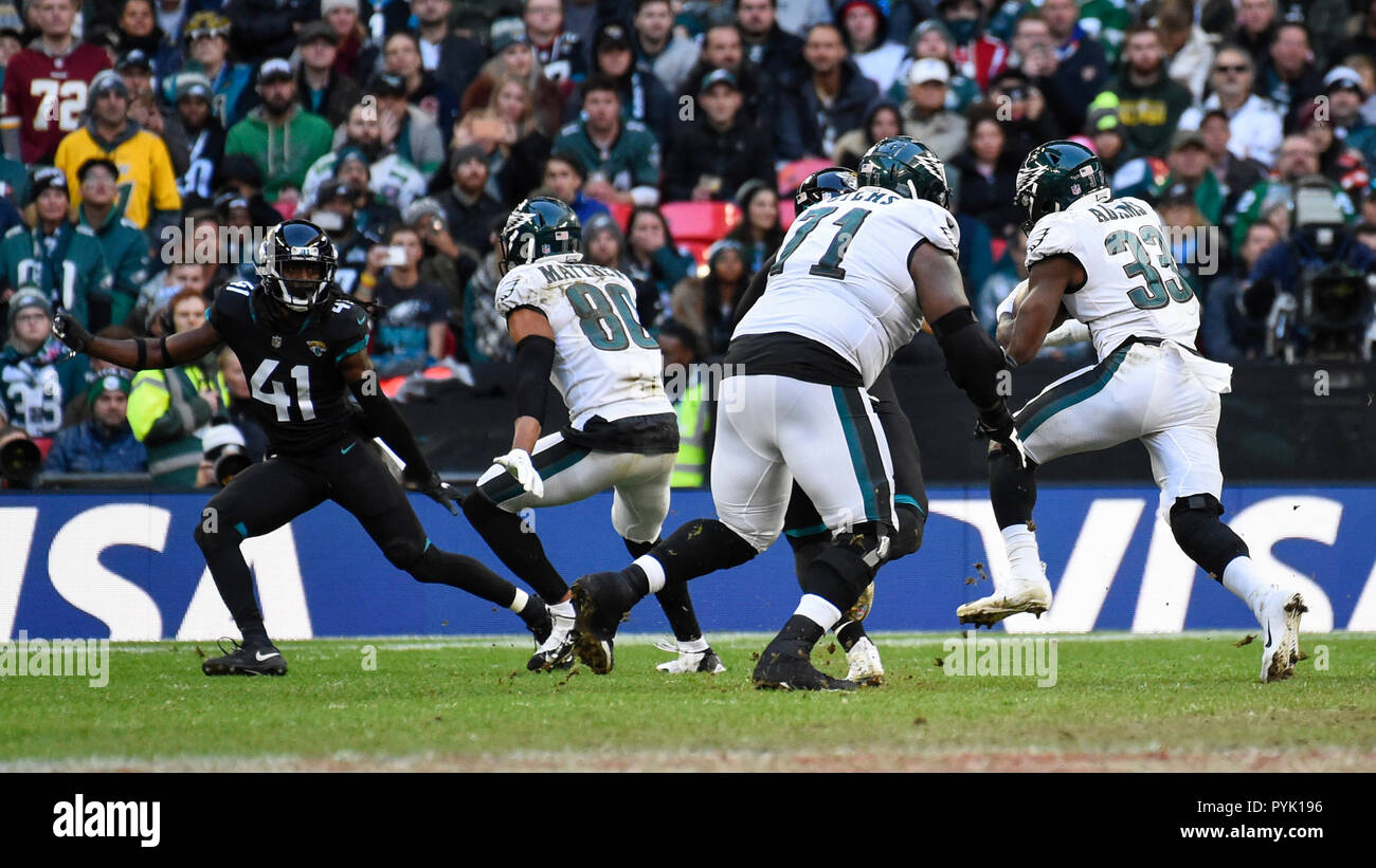 London, UK. 28 October 2018. Eagles running back Josh Adams (R) (33) in  possession. Philadelphia Eagles at Jacksonville Jaguars NFL game at Wembley  Stadium, the final game in the NFL London 2018