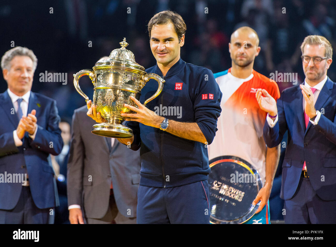 St Jakobshalle, Basel, Switzerland. 28th Oct, 2018. ATP World Tour, Swiss  Indoor Tennis; Roger Federer receives his winners trophy after the singles  final watched on by tournament director Roger Brennwald, deputy tournament