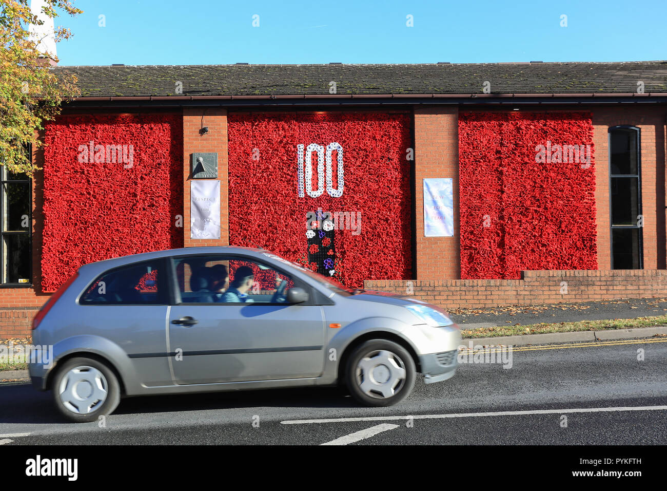 Bromsgrove, Worcestershire, UK. 29th October, 2018. A stunning display featuring 12,500 hand-knitted poppies adorns Bromsgrove Methodist Church walls. The centrepiece has the number '100' made with white wool poppies, a symbol of peace. Purple poppies also feature which commemorates the many animals - mainly horses - who were in the First World War. The poppies came from all over the UK, but most were made by local people in Bromsgrove. Peter Lopeman/Alamy Live News Stock Photo