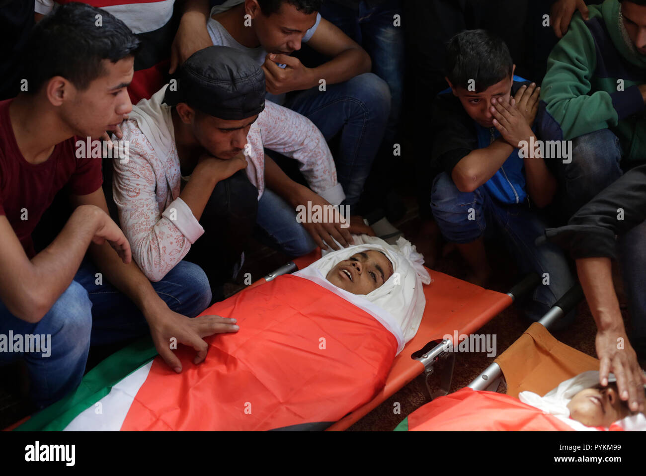 EDITORS NOTE: Image depicts death.) The child's dead body seen being  surrounded by mourners during their funeral after an Israeli shelling took  their life near the Gaza-Israel border in Gaza. The three