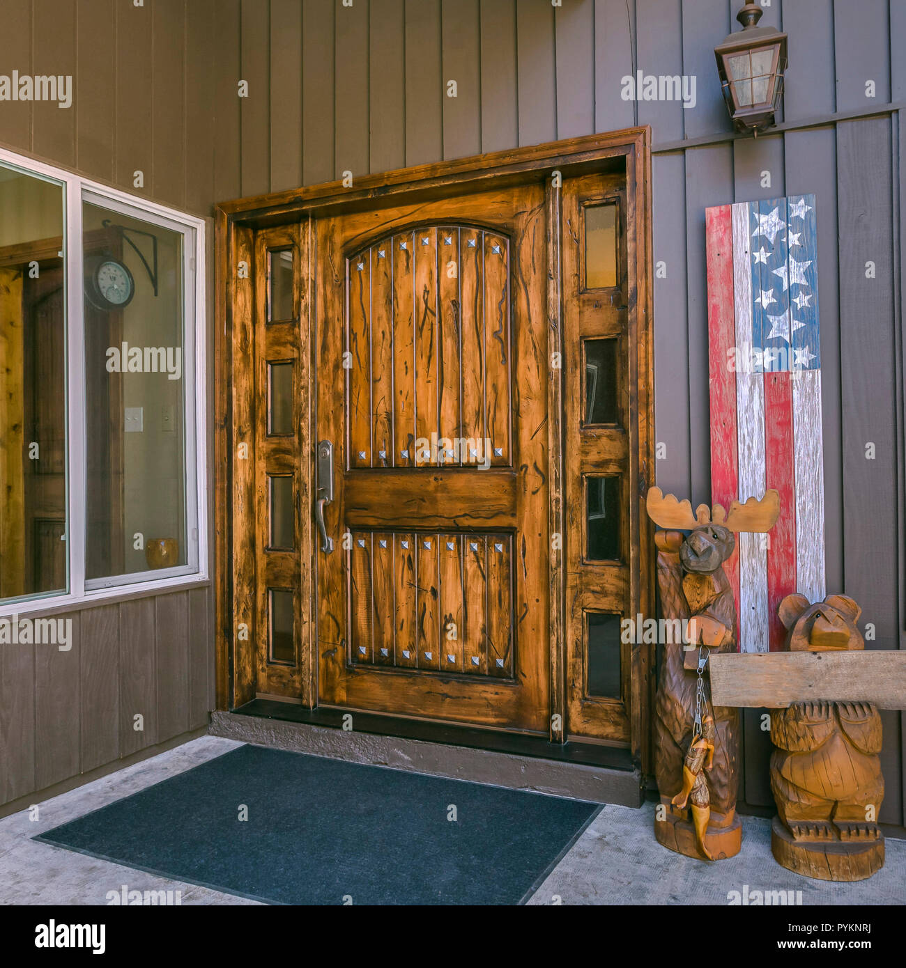 Brown Door With Glass Panels And American Flag Stock Photo