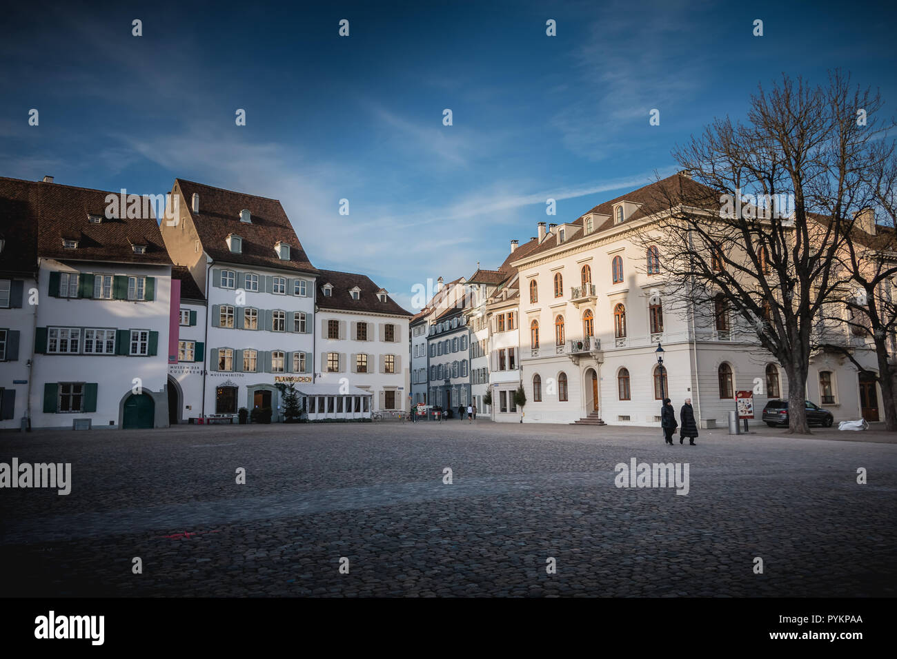 Basel, Switzerland - December 25, 2017 - Warmly dressed people walk on cathedral square on a winter's day Stock Photo