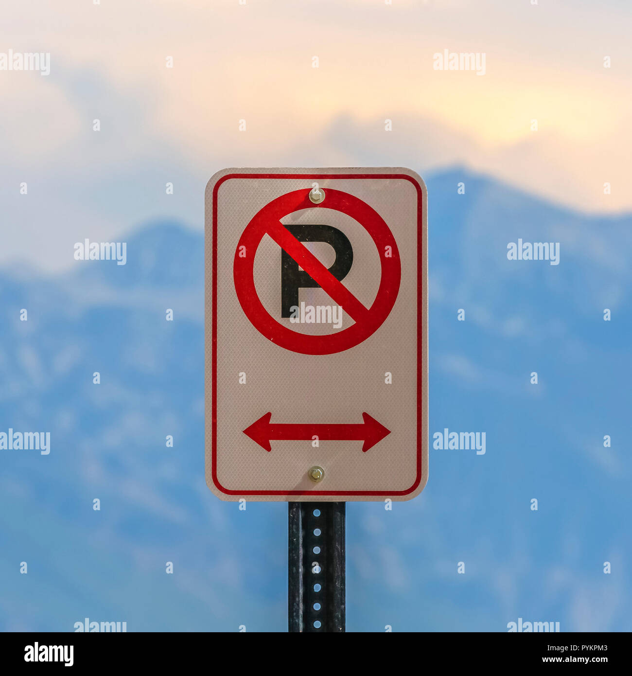 No parking sign against a blurry mountain and sky Stock Photo - Alamy