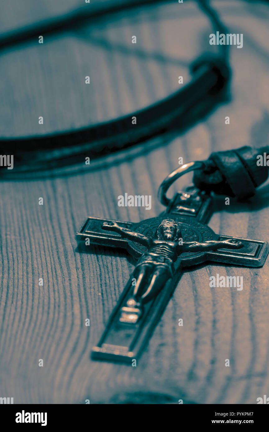 Crucifix cross necklace on a wood background with toning Stock Photo