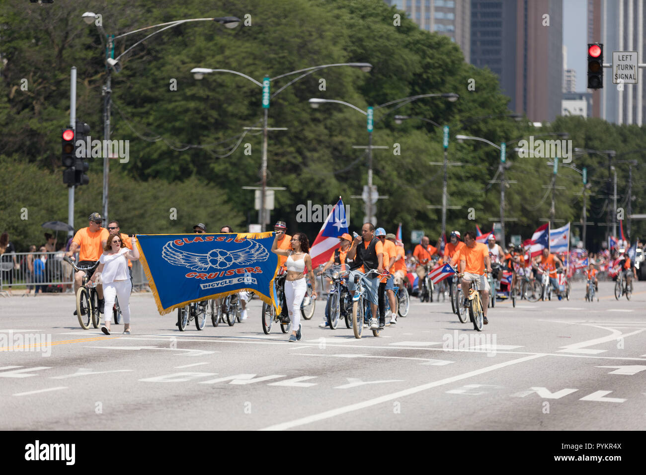 Chicago, Illinois, USA - June 16, 2018: The Puerto Rican Day Parade, Members of the Classic Cruisers Bicycle Club riding a bicycles with the puerto ri Stock Photo