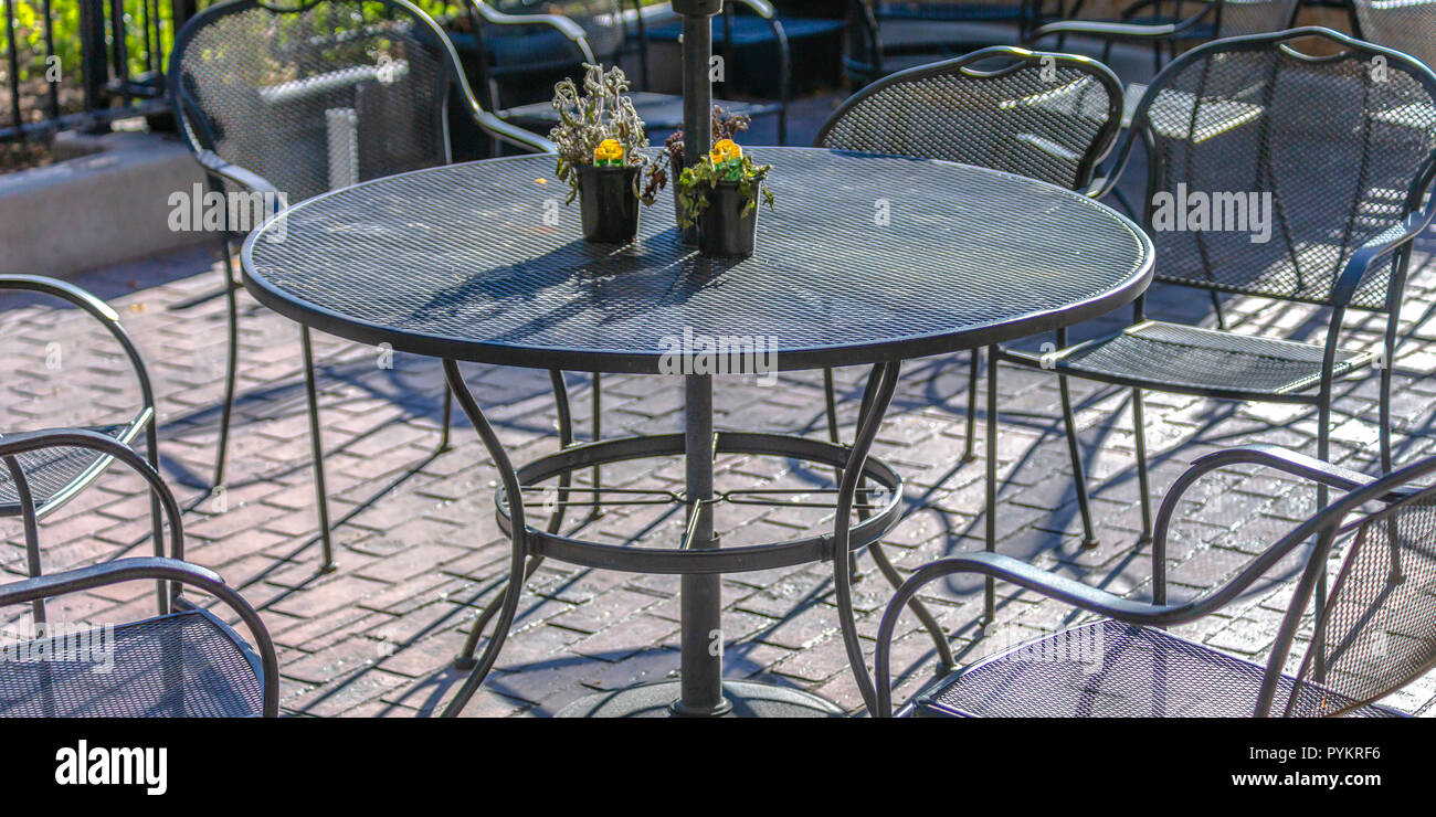Sunlit metal table and chairs outside of restaurant Stock Photo Alamy