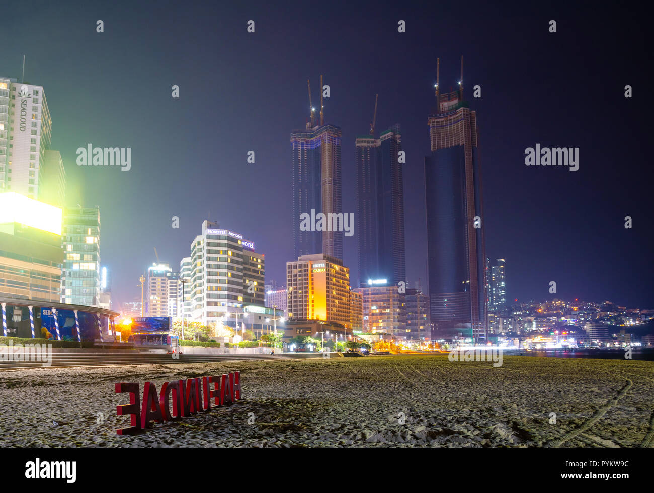 Haeundai Beach At Night With Skyscrapers Of The City Lit Up