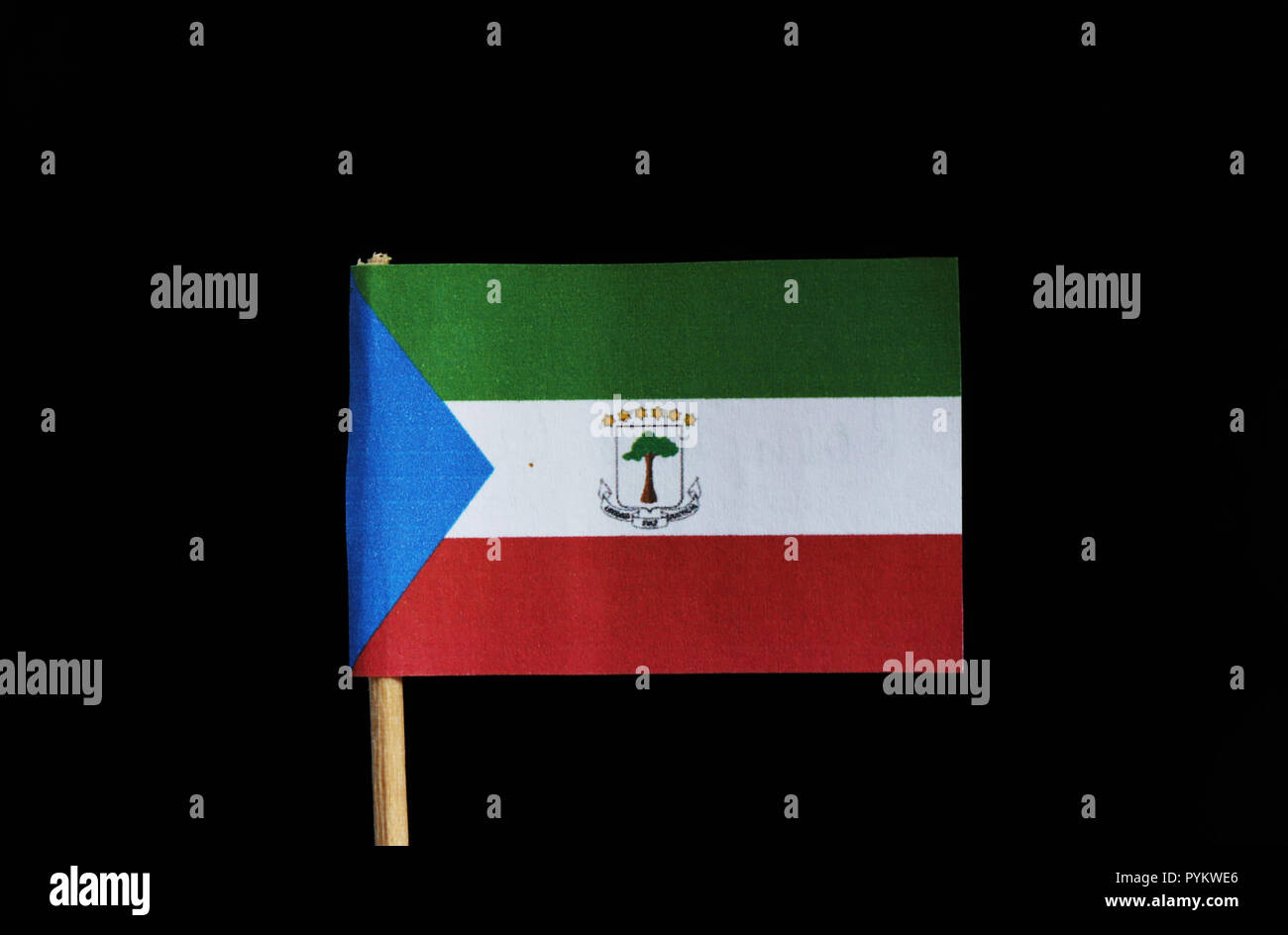A official flag of Equatorial Guinea on toothpick on black background. Equatorial Guinea is located in central africa. The flag is created four colour Stock Photo