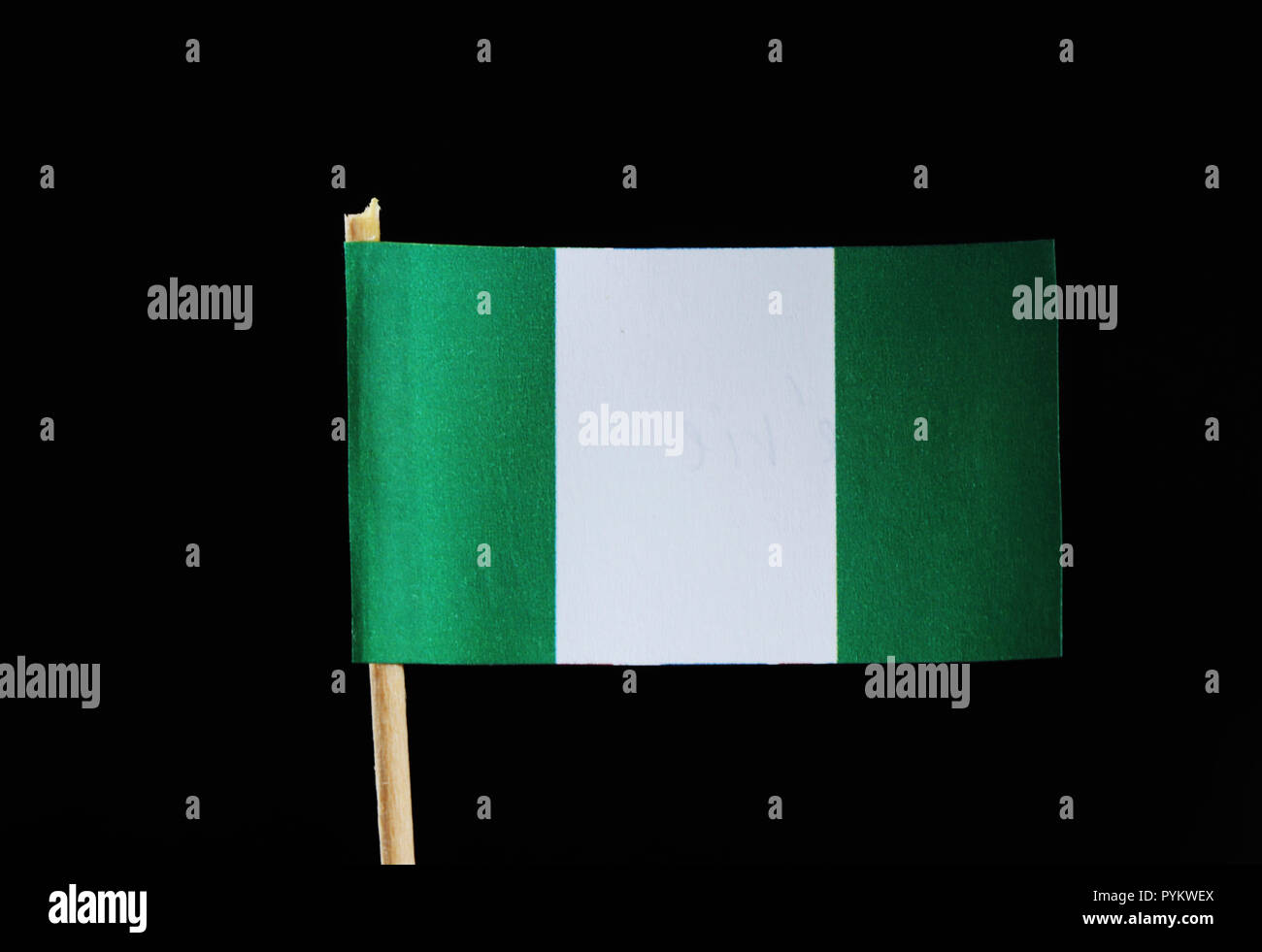 A national flag of Nigeria on toothpick on black background. Nigerian