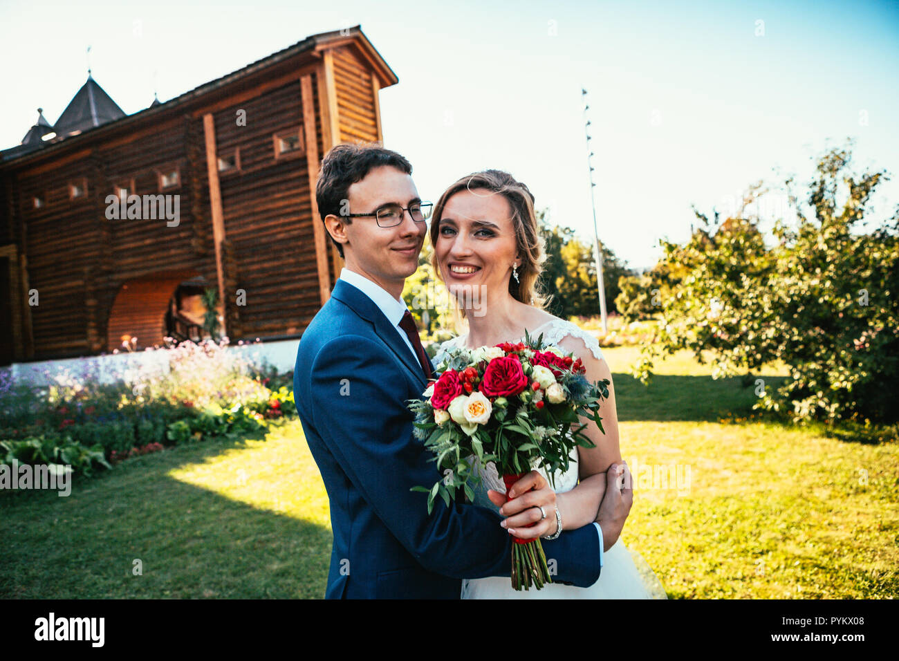 Walk young bride and groom on old house background Stock Photo - Alamy