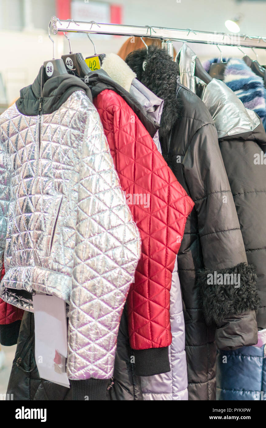 Winter Jacket in Winter Sale on a clothes rack. Women's coats on hangers in  a women's clothing store. vertical photo Stock Photo - Alamy