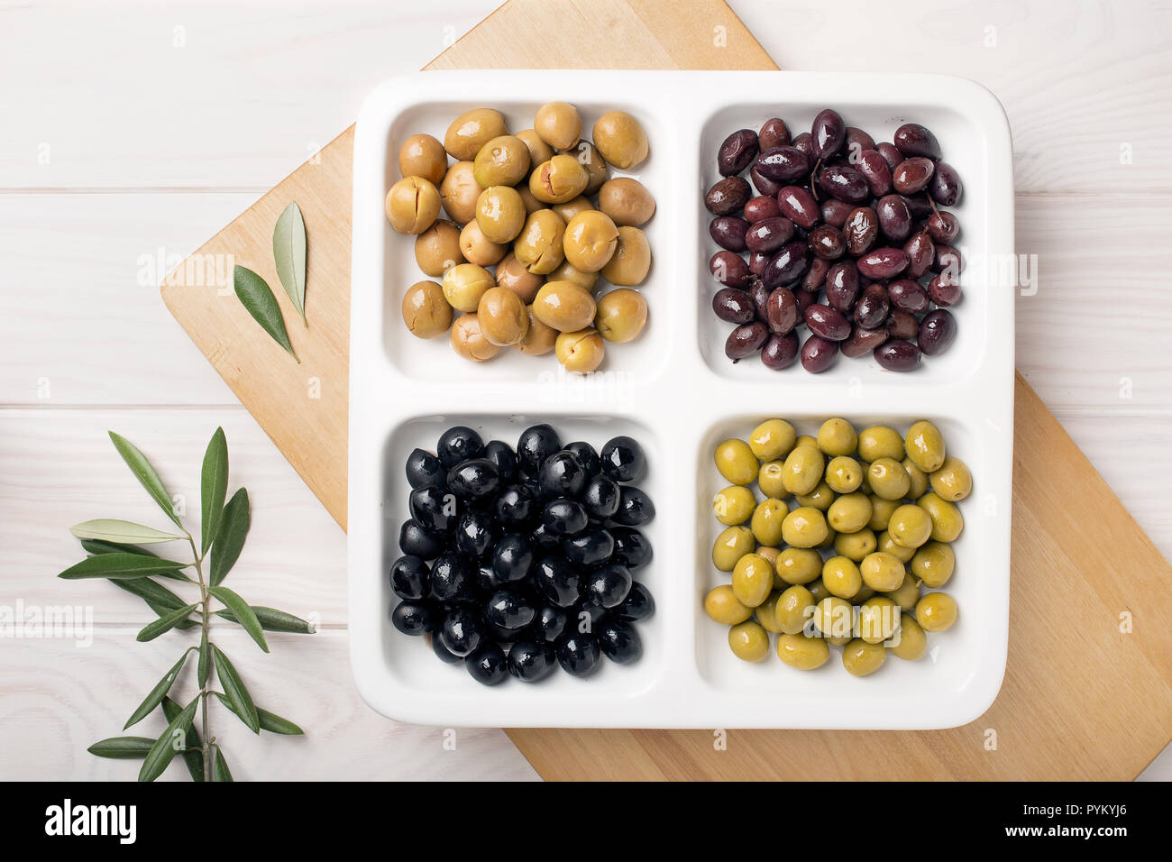 Olive appetizer. Green black aragon and split olives. Tasty mediterranean food Stock Photo