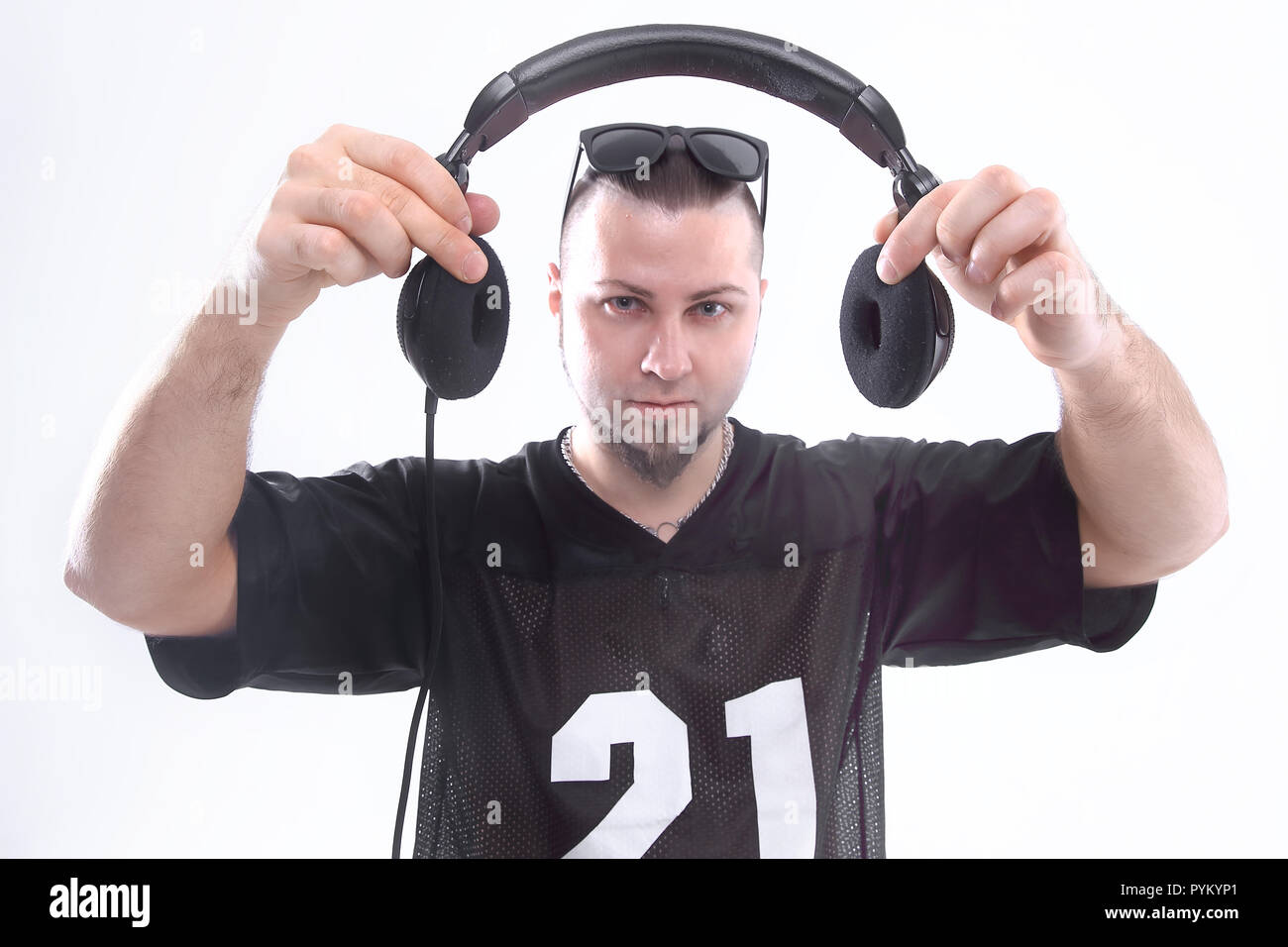 close up. stylish rapper shows headphones .isolated on white Stock ...