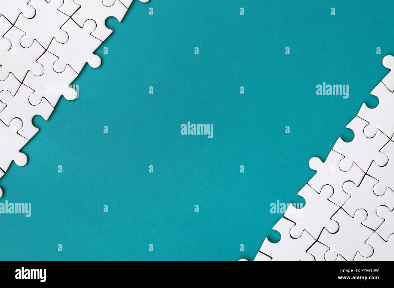 https://c8.alamy.com/comp/PYM10W/fragment-of-a-folded-white-jigsaw-puzzle-on-the-background-of-a-blue-plastic-surface-texture-photo-with-copy-space-for-text-PYM10W.jpg