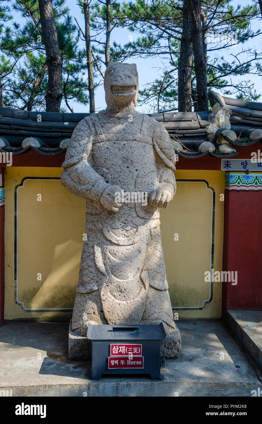 Stone sculpture representing the horse deity from the Chinses Zodiac, seen here at Haedong Yonggung Temple, Busan, South Korea. Stock Photo