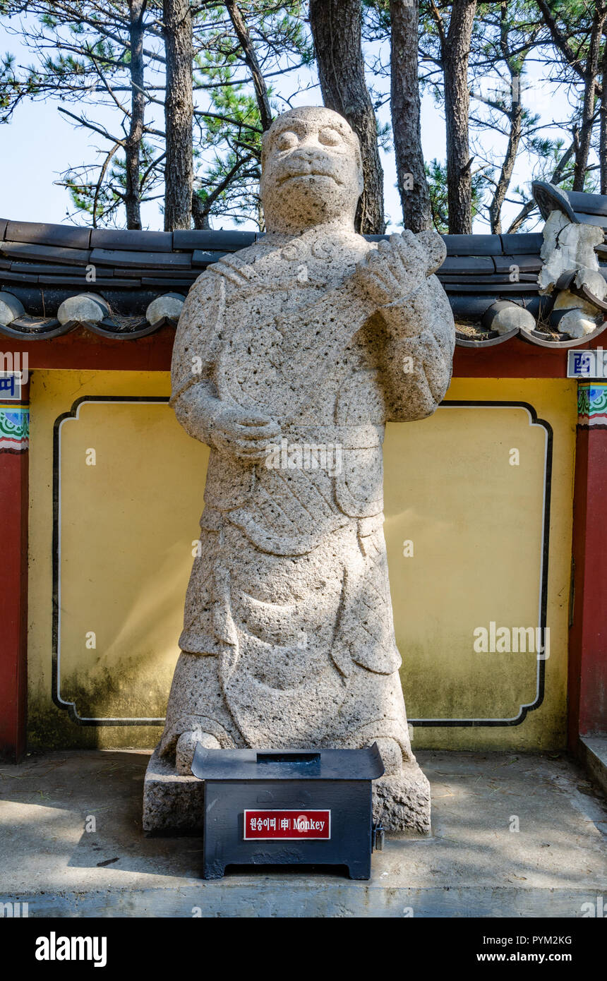 Stone sculpture representing the monkey deity from the Chinses Zodiac, seen here at Haedong Yonggung Temple, Busan, South Korea. Stock Photo