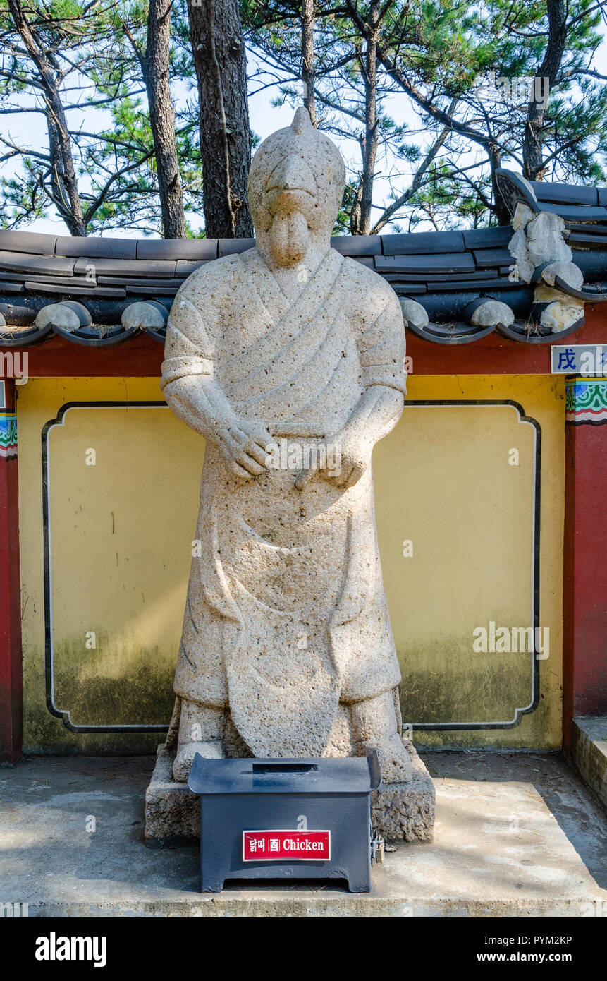 Stone sculpture representing the chicken deity from the Chinses Zodiac, seen here at Haedong Yonggung Temple, Busan, South Korea. Stock Photo
