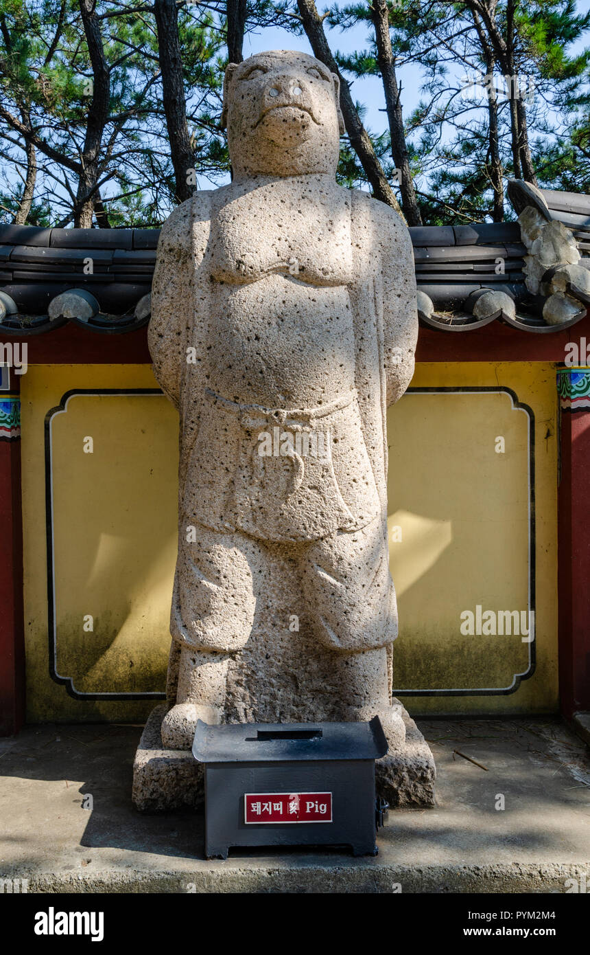 Stone sculpture representing the pig deity from the Chinses Zodiac, seen here at Haedong Yonggung Temple, Busan, South Korea. Stock Photo