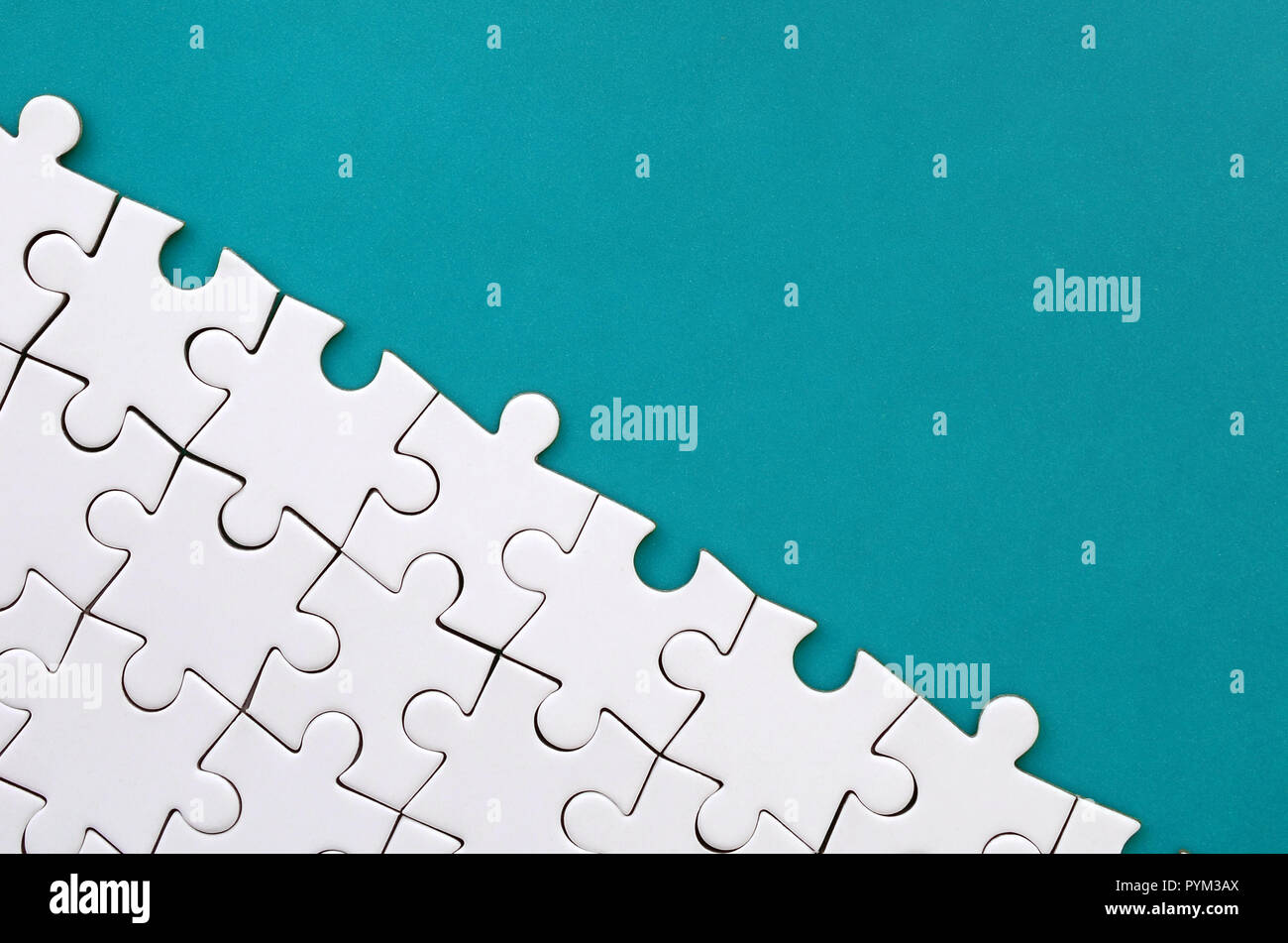 https://c8.alamy.com/comp/PYM3AX/fragment-of-a-folded-white-jigsaw-puzzle-on-the-background-of-a-blue-plastic-surface-texture-photo-with-copy-space-for-text-PYM3AX.jpg