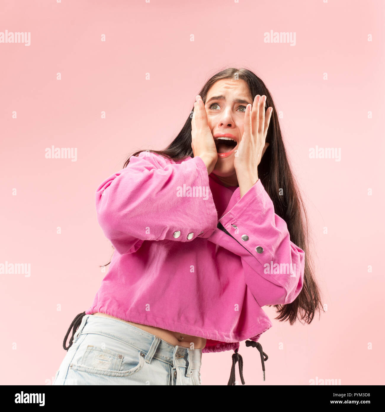 I'm afraid. Fright. Portrait of the scared woman. Business woman standing isolated on trendy pink studio background. Female half-length portrait. Human emotions, facial expression concept Stock Photo
