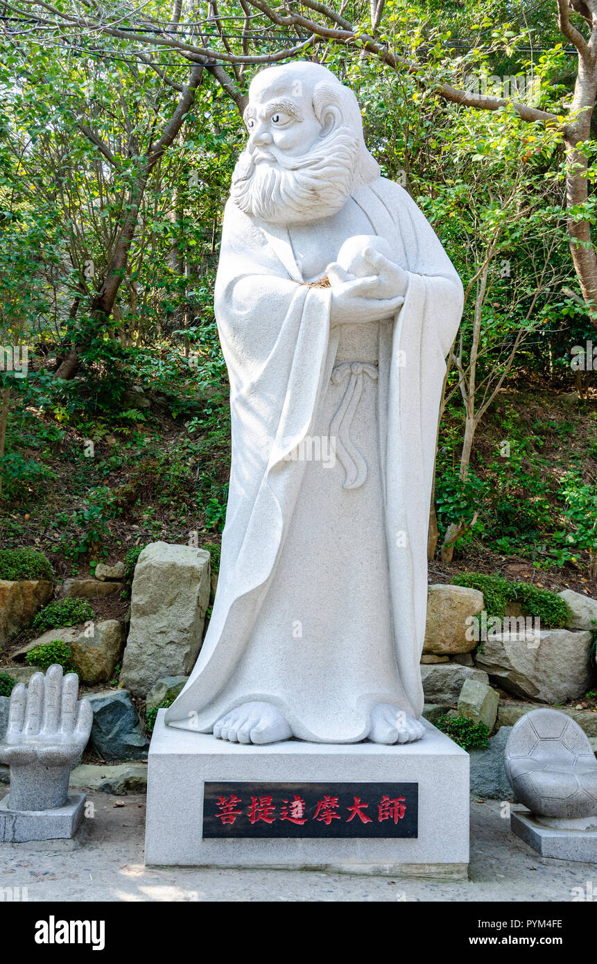 A stone statue of a bearded man wearing robes at Haedong Yonggung Temple in Busan, South Korea. Stock Photo