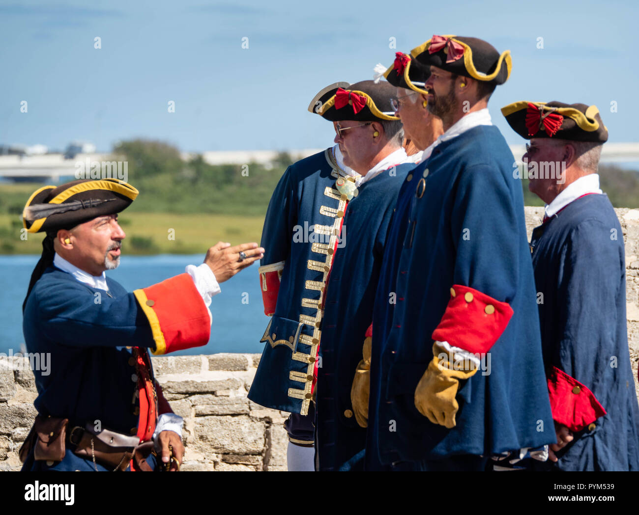 Men in eighteenth century Spanish period costume at Castillo de San Marcos in St Augustine Florida USA preparing to fire a cannon Stock Photo