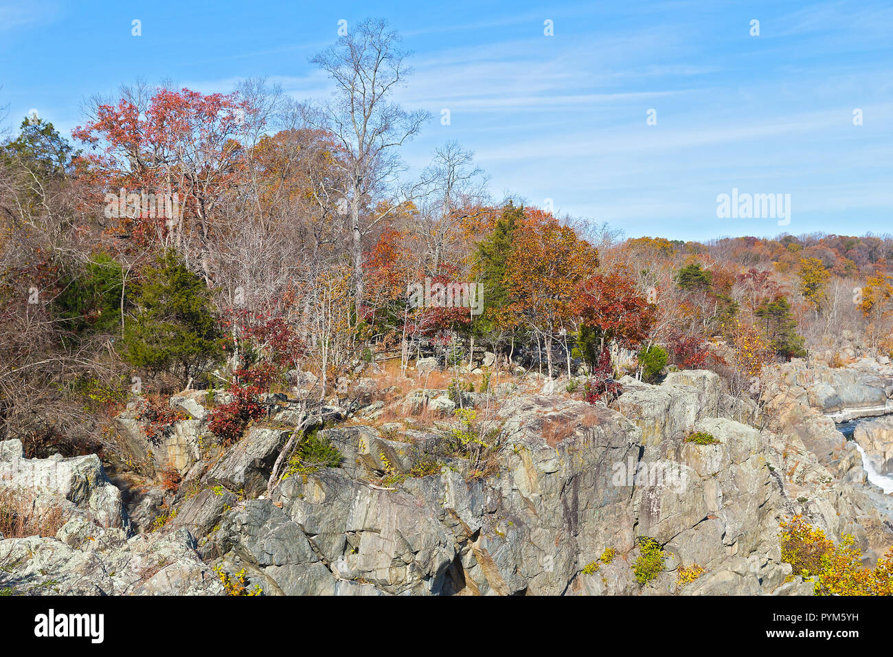 Rocky riverbank of Potomac river in autumn. Great Falls State Park trails run across rocky terrain along the water. Stock Photo