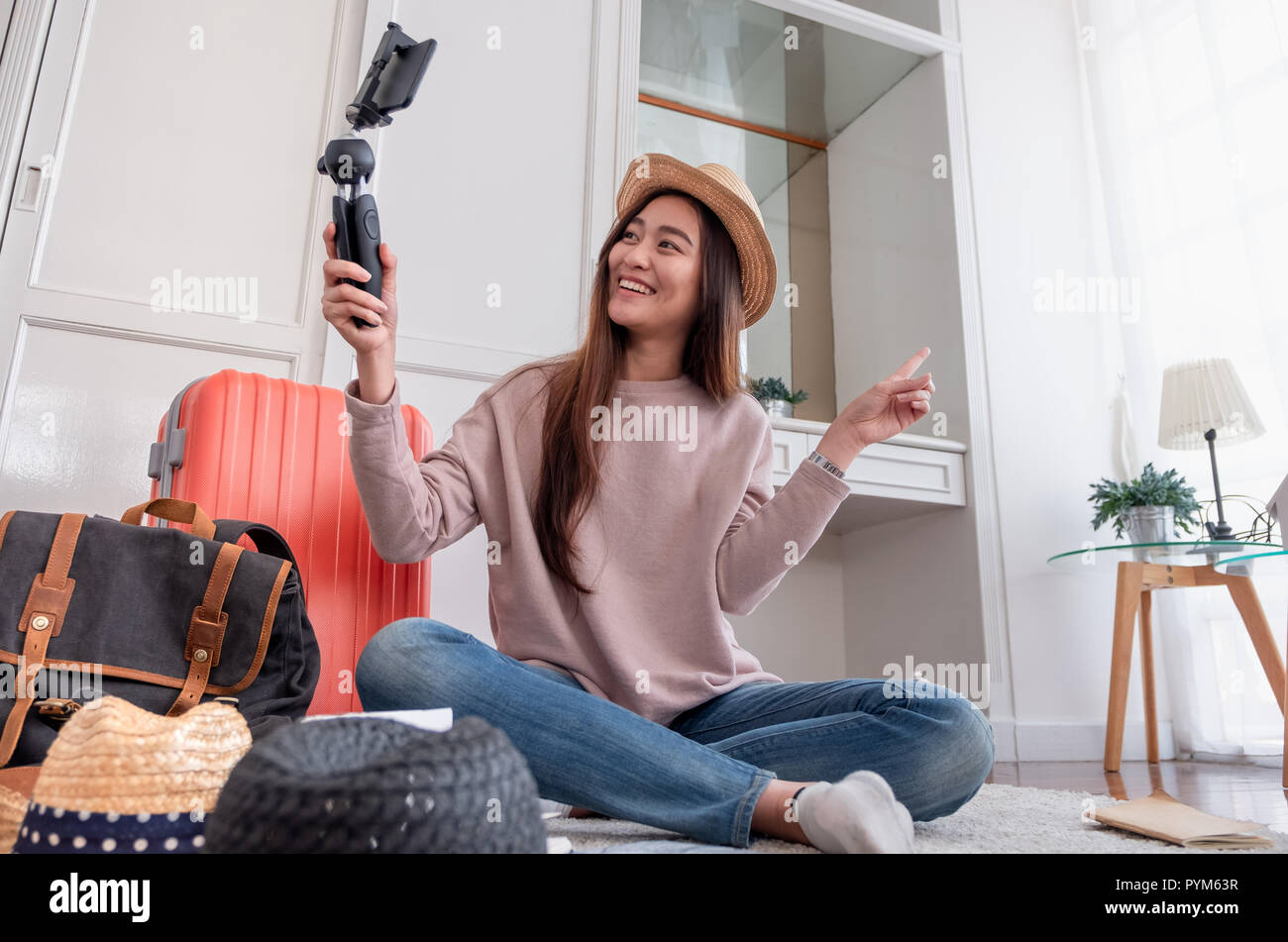 Asian young female blogger recording vlog video with mobile phone live streaming when travel.online influencer on social media viral concept Stock Photo