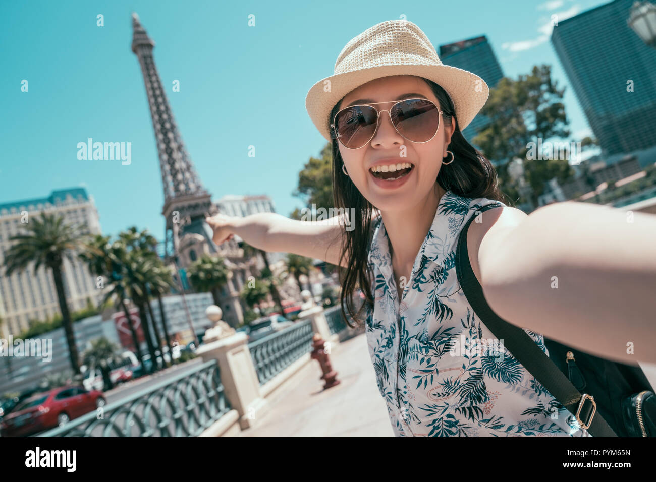 Asian woman taking self portrait selfie photo on America travel. tall tower in Las vegas. Young girl enjoying tourism in USA in summer holiday. Stock Photo