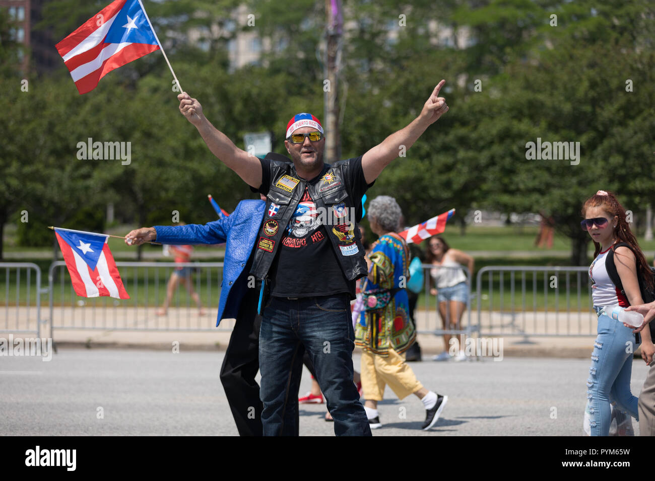 Chicago, Illinois, USA - June 16, 2018: The Puerto Rican Day Parade, Puerto Rican people carrying puerto rican flags celebrating during the parade Stock Photo