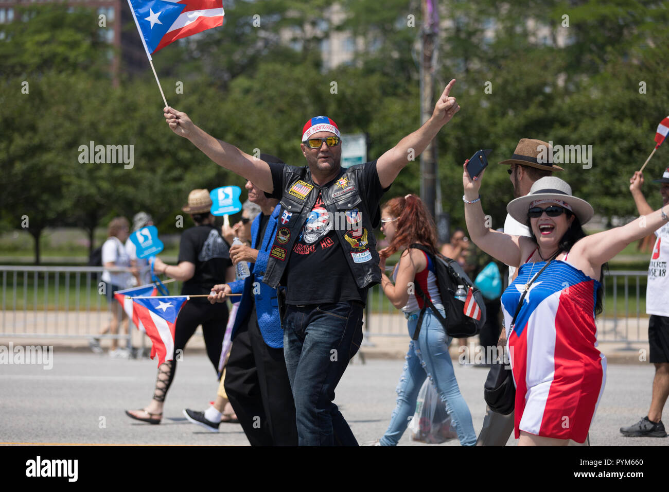 Chicago, Illinois, USA - June 16, 2018: The Puerto Rican Day Parade, Puerto Rican people carrying puerto rican flags celebrating during the parade Stock Photo