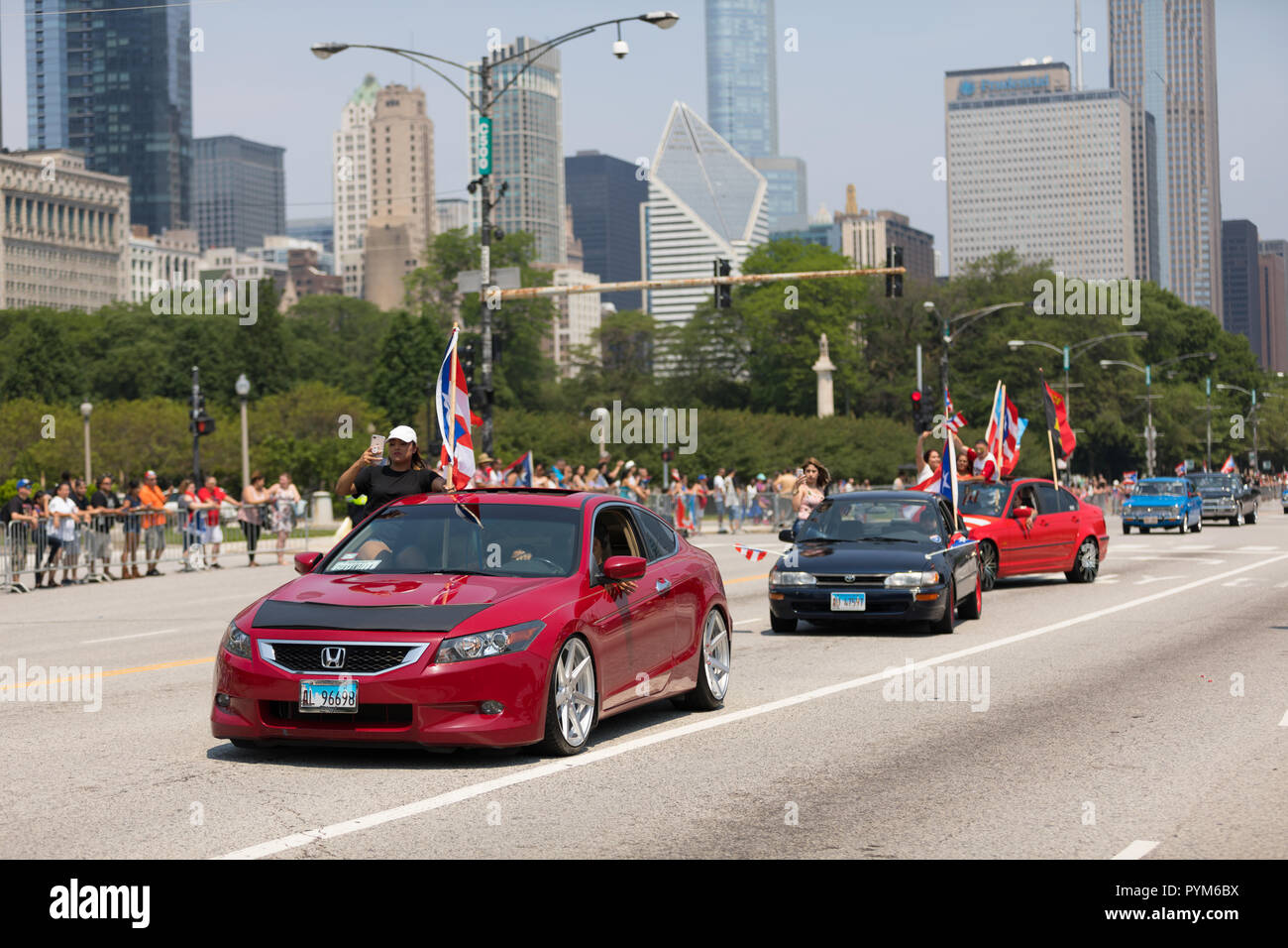 Chicago, Illinois, USA - June 16, 2018: The Puerto Rican Day Parade, Puerto Ricans driving a Honda Accord red  with puerto rican flags on them during  Stock Photo