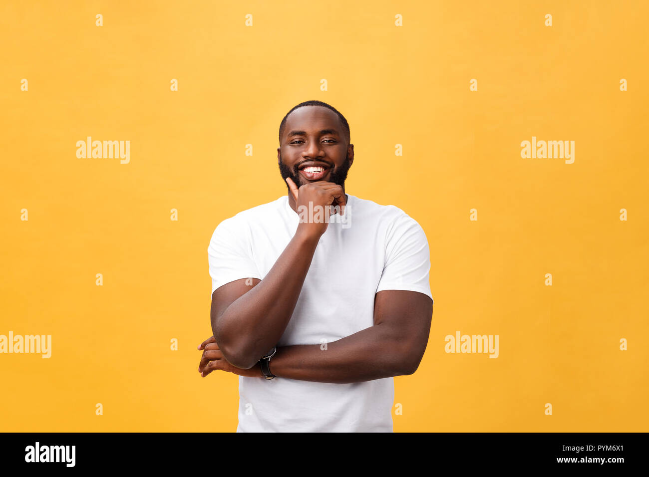 Portrait of a modern young black man smiling with arms crossed on ...