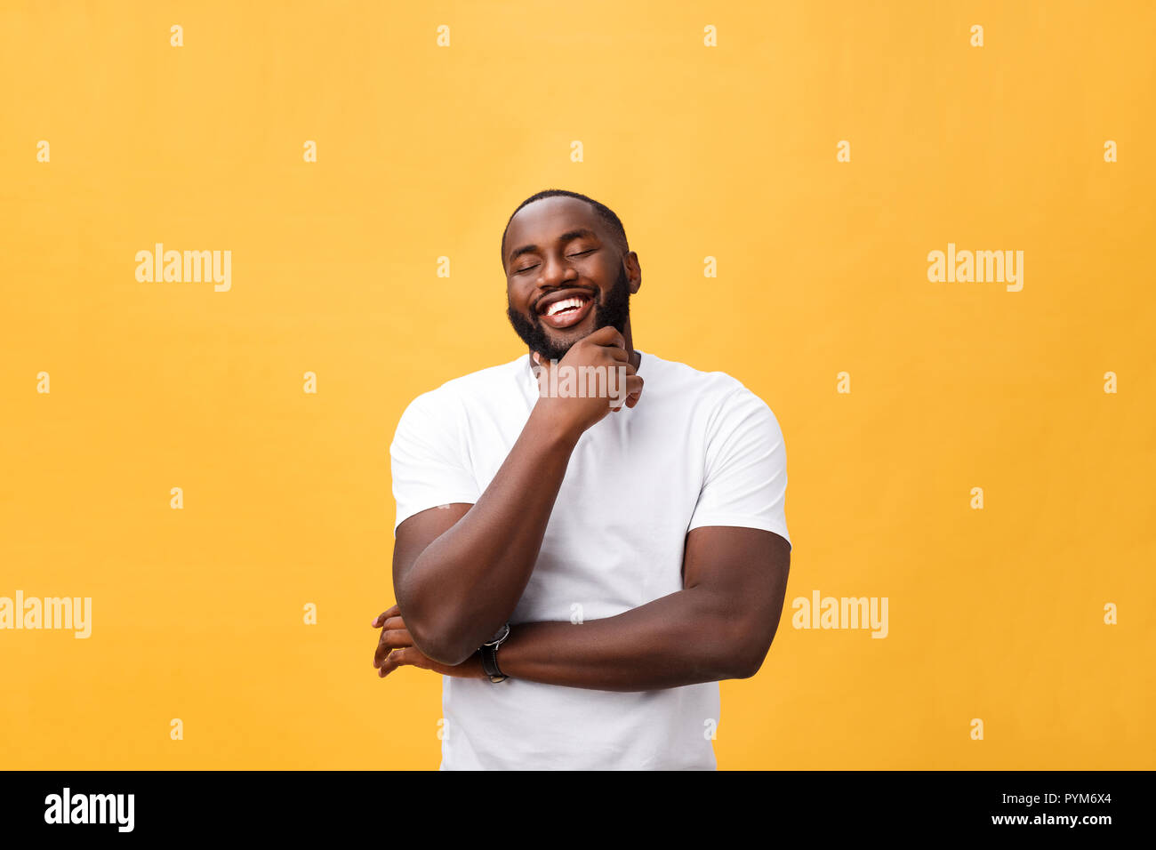 Portrait of a modern young black man smiling with arms crossed on ...