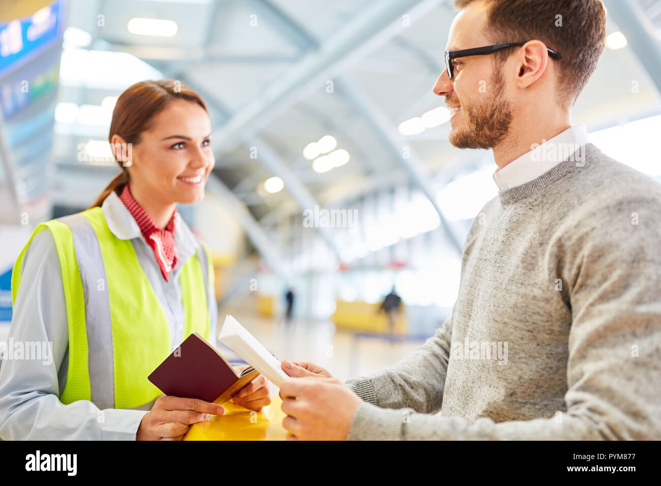Man as a traveler at the airport Check in counter is controlled at entry Stock Photo