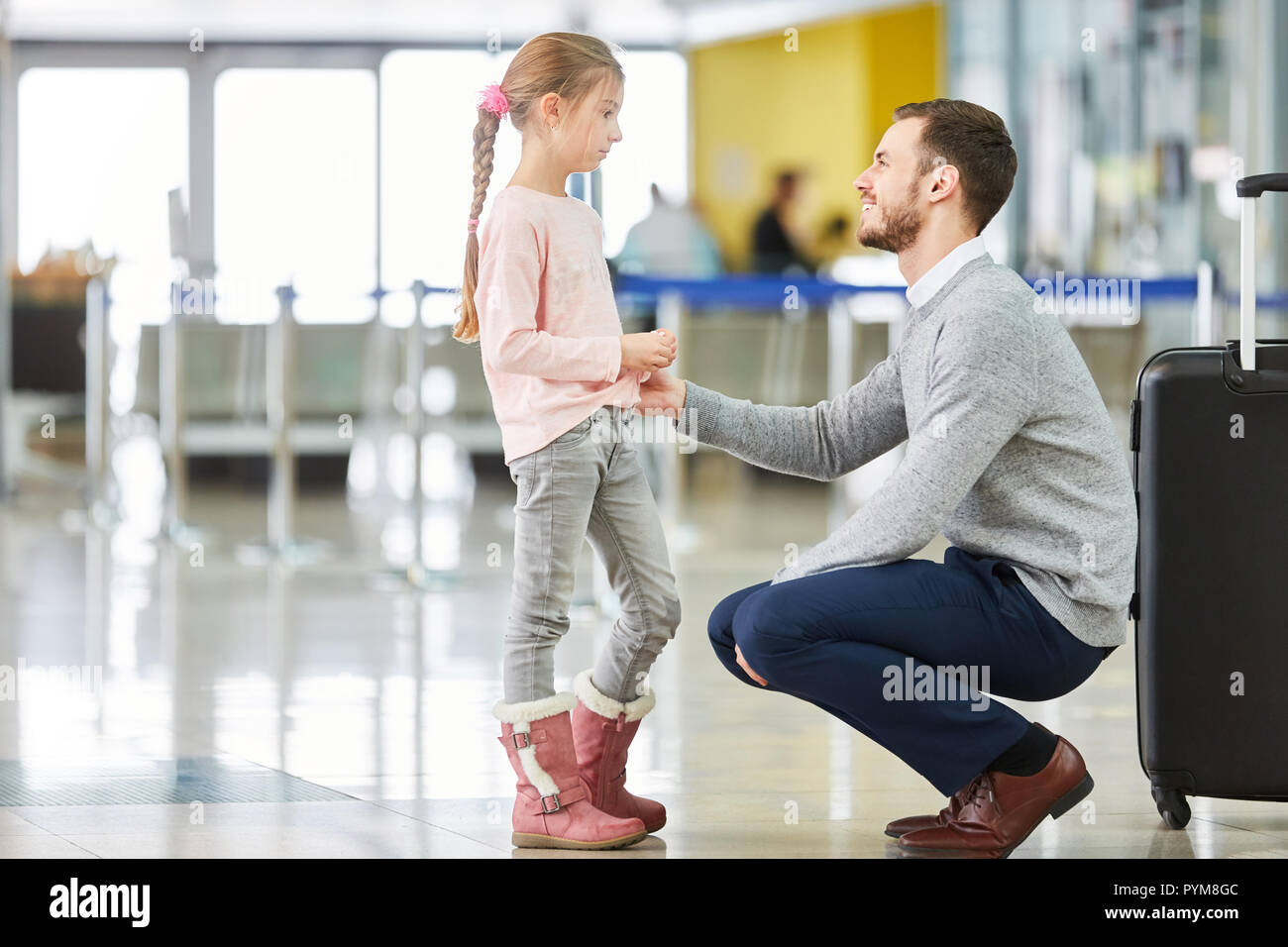 Father and daughter in the airport terminal travel together on vacation ...