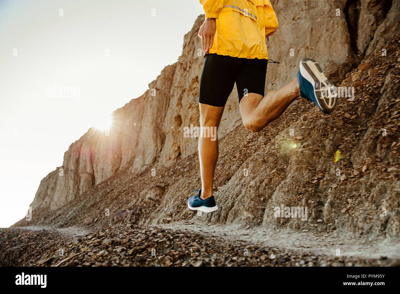 concept healthy lifestyle man runner running on mountain trail in sunset Stock Photo